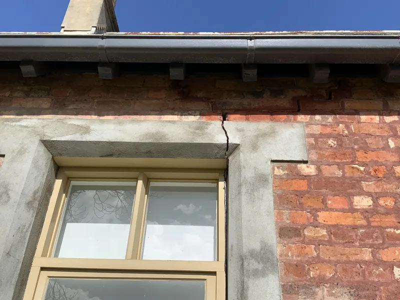 Crack running up through the stone window head of the 95-year-old Berwick cottage before foundation repair