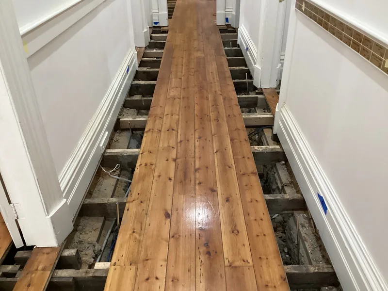 Hallway floorboards lifted down both sides to reach GeoPoly™ injection points beneath the Berwick cottage