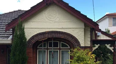 Front gable and brick arch of the Annandale home before repair