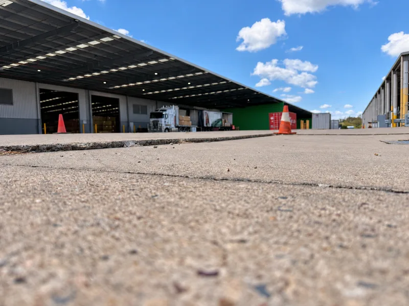 Before: step between hardstand slabs along the joint at the Bundamba warehouse, looking down the loading bays