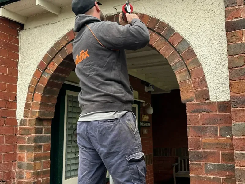 Buildfix technician repairing brick archway