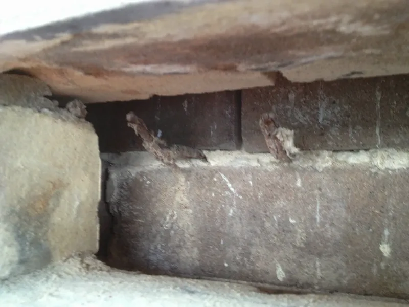 Corroded and snapped cavity wall ties inside the brick cavity of the Marrickville corner store, seen with an inspection camera