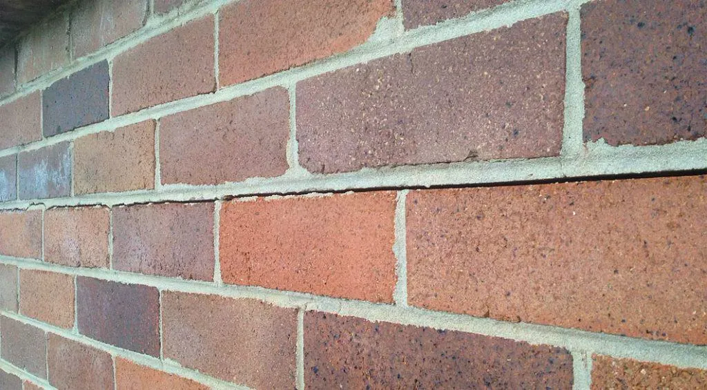 Close-up of freshly repointed mortar joints on the heritage fairground wall after repair