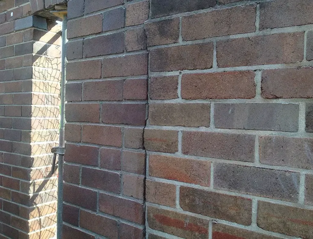 Repaired corner pier junction of heritage wall with colour-matched mortar repointing