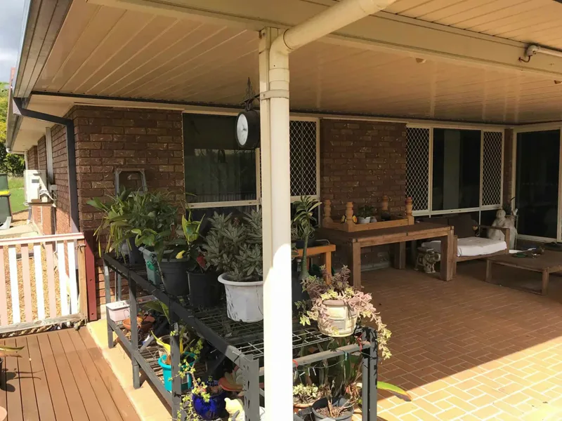 Covered verandah along the side of The Gap home, its brick wall and tiled floor sitting on the slab that was lifted