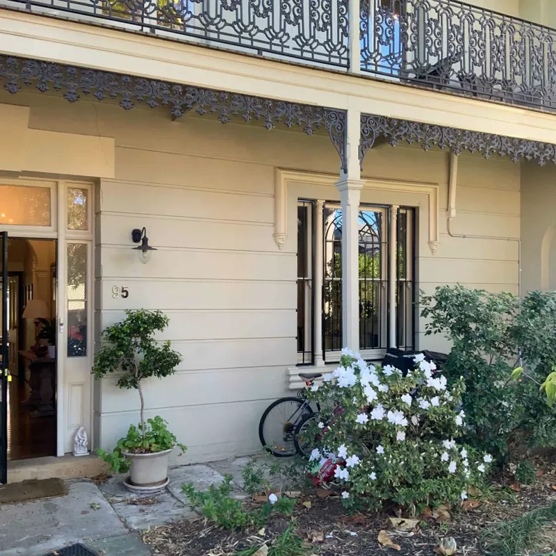 Front of the Georgian home in Newtown with its iron lace balcony, before wall crack repair