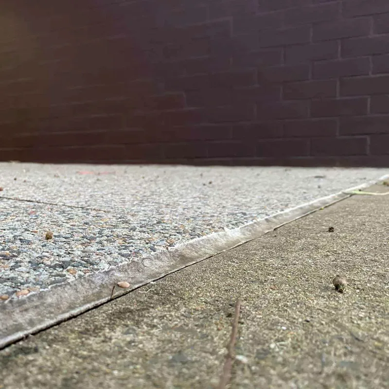 The same paving edge outside the Newington apartment block sitting flush after GeoPoly™ was injected beneath it