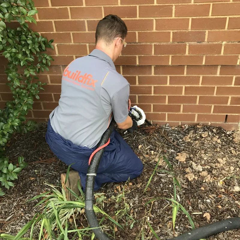 GeoPoly™ injection hose run along the garden bed to the footing of the Lidcombe townhouse