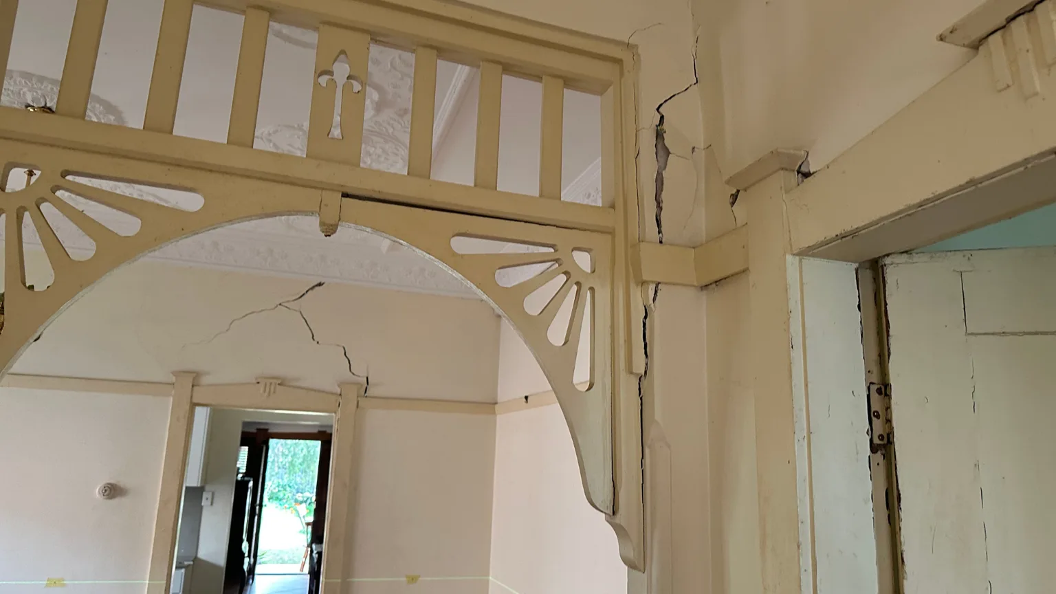 Structural cracking extending from rear bedroom into living room walls