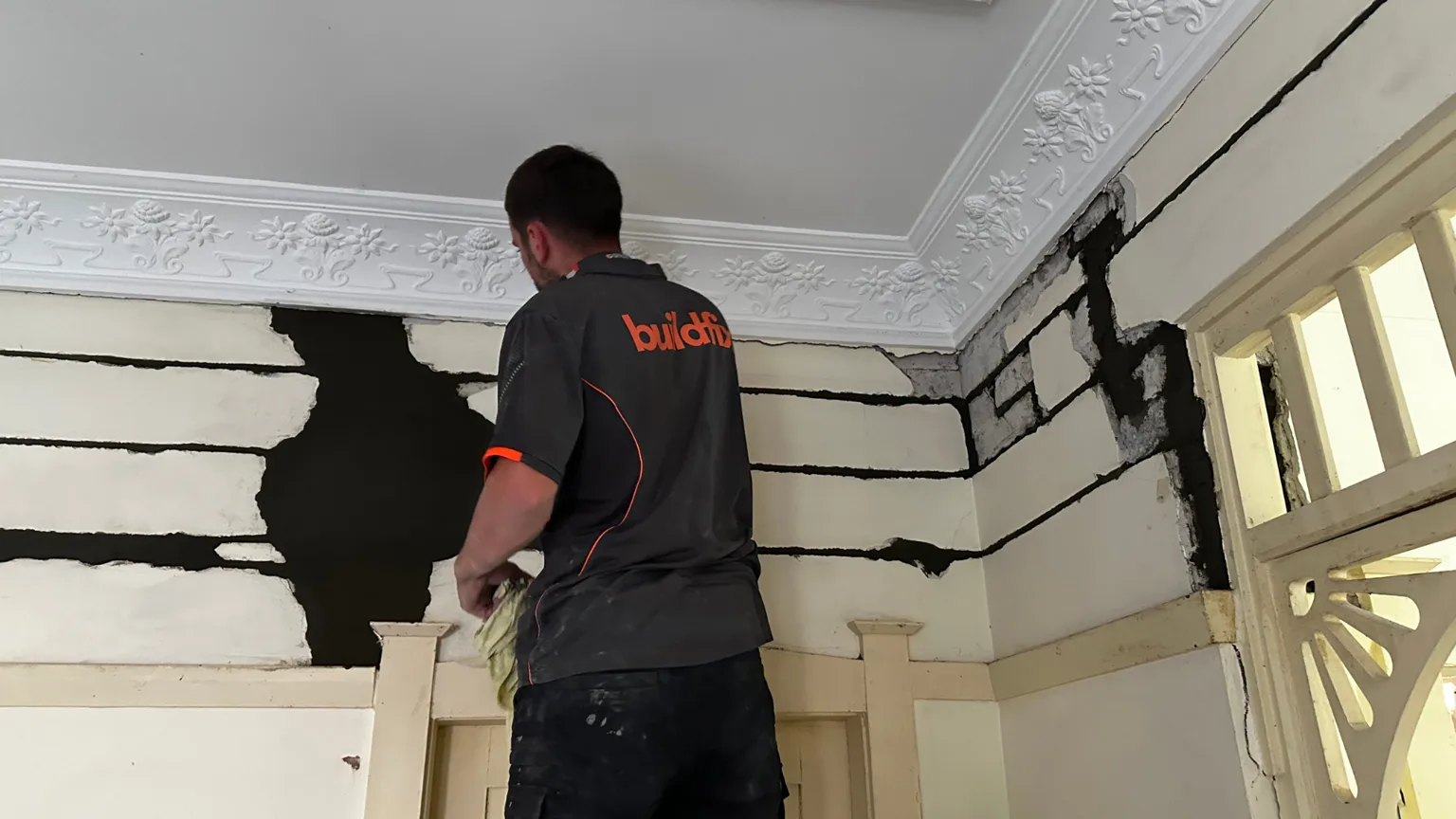 Buildfix technician installing HelicalBars in continuous runs across cracked brickwork