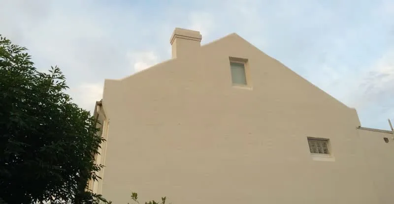 Restored and rendered gable end wall of Victorian terrace in Rozelle after remedial wall tie repair