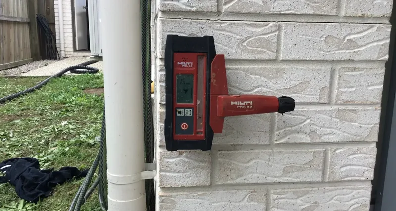 A bricklaying level laser measuring the height the lift of the masonry wall