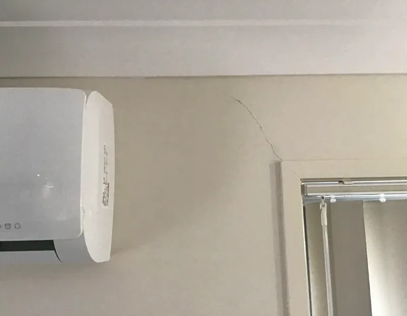 The same internal wall of the Morayfield house after the lift, the crack above the window closed