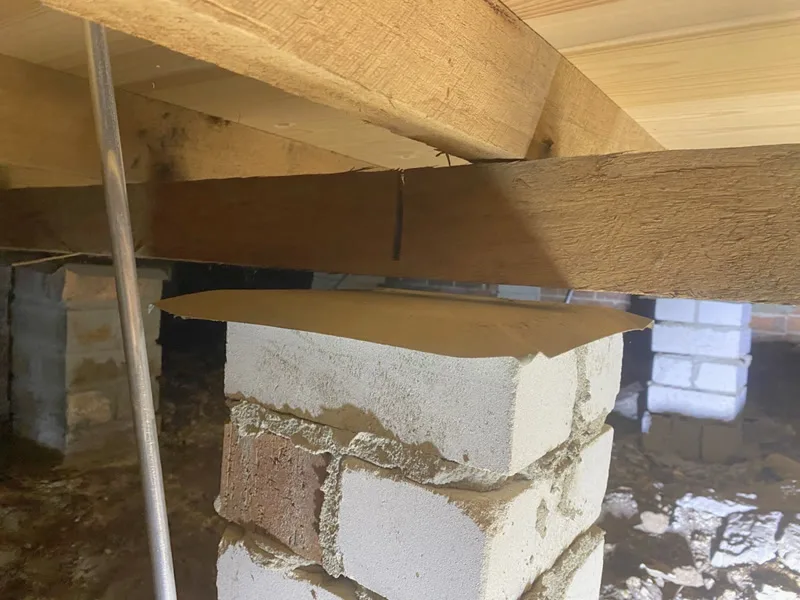 Brick pier beneath subfloor showing gap at bearer