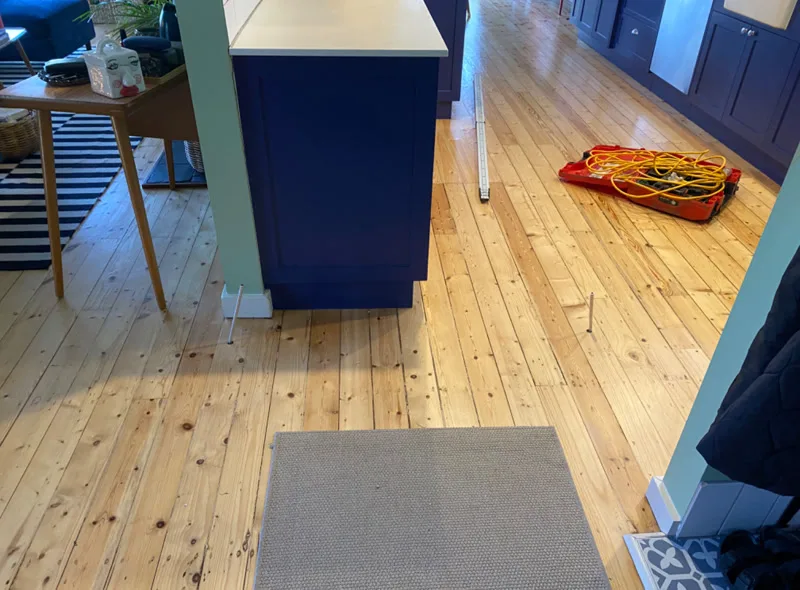 Kitchen with Buildfix equipment on timber floor — kitchen untouched during repair