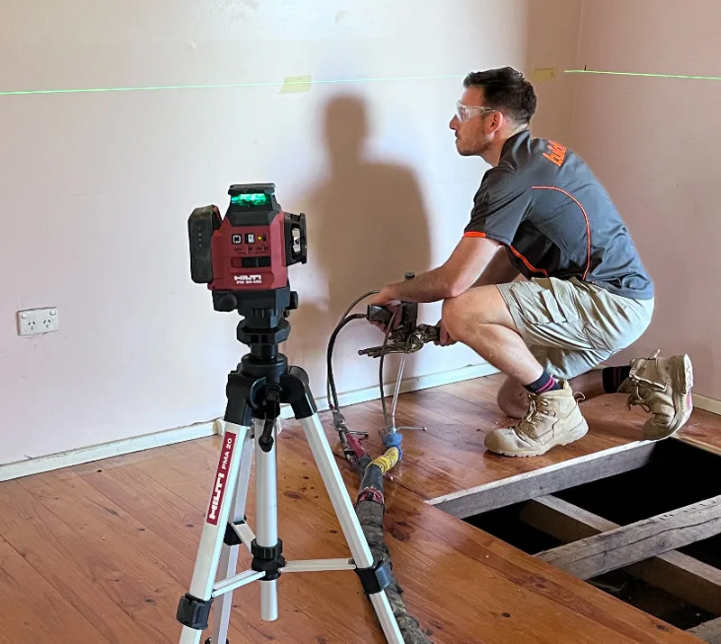 Buildfix technician with Hilti laser equipment performing deep-lift injection