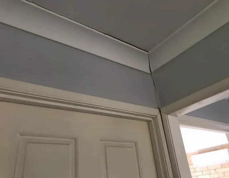 Crack opening through the cornice and wall above a door inside the Brisbane bungalow before the slab was stabilised