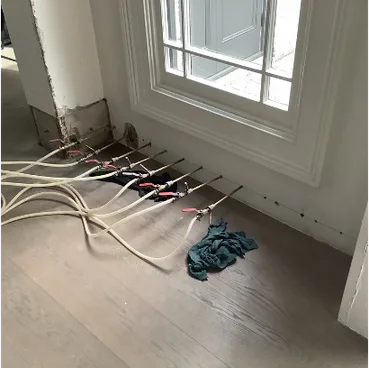 DampBlock injection hoses connected along base of terrace wall at Stanmore home