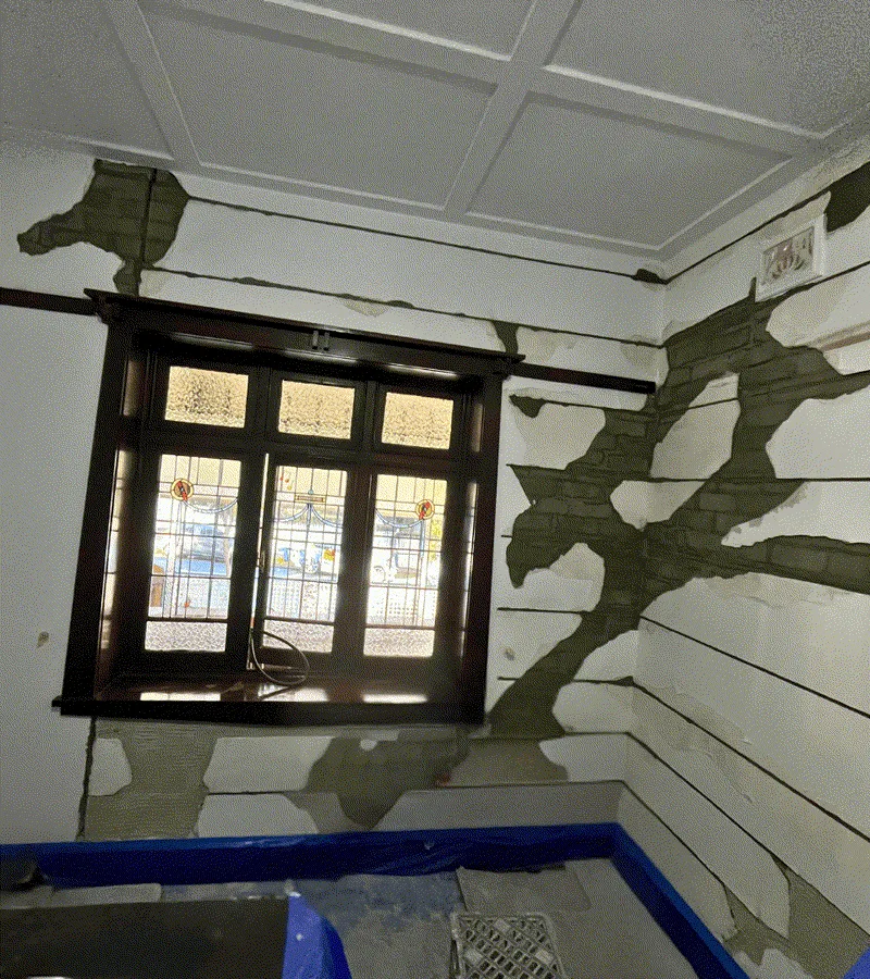 Interior wall with plaster stripped back showing HelicalBar cuts and cracking