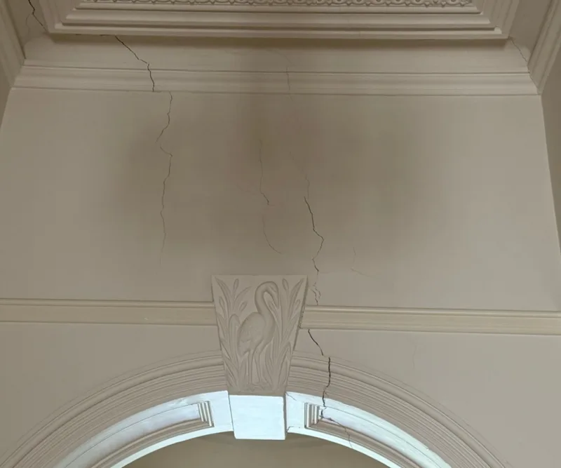 Cracks spreading from hallway archway to ceiling in Victorian home