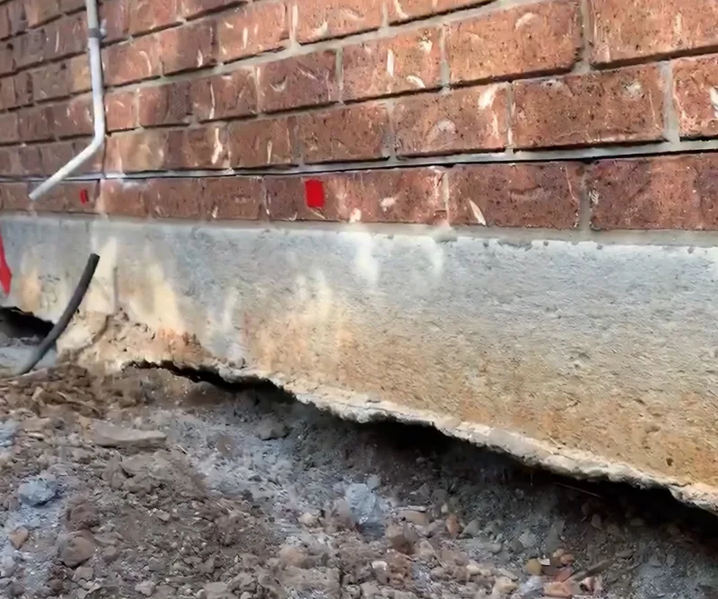 Conventional concrete slab foundation under a Brisbane home showing subsidence