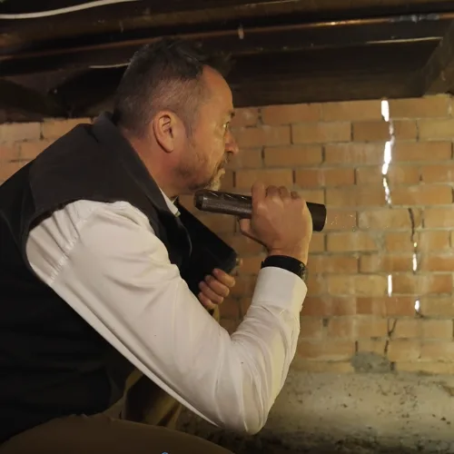 Buildfix technician injecting DampBlock resin into brick wall for salt damp repair