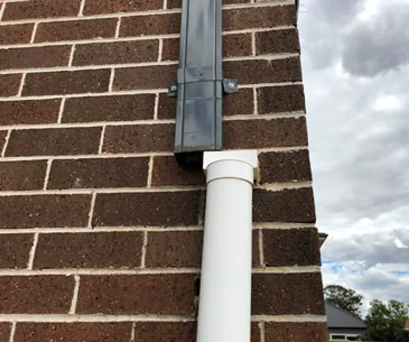 Older brick home with no damp proof course showing rising damp damage at the base of walls