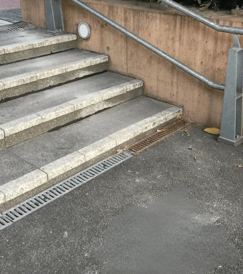 Same stairs relevelled with even step edges and drainage grate installed
