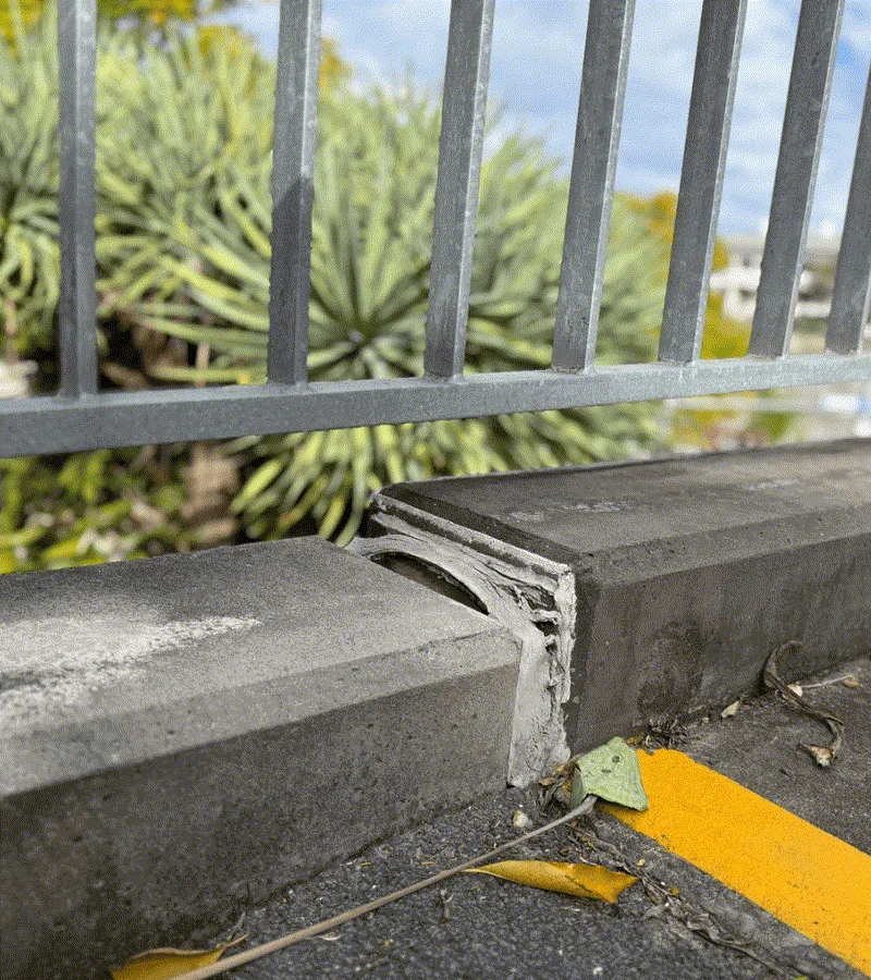 Sunken concrete kerb pulling away from railing base at Roma Street Parkland