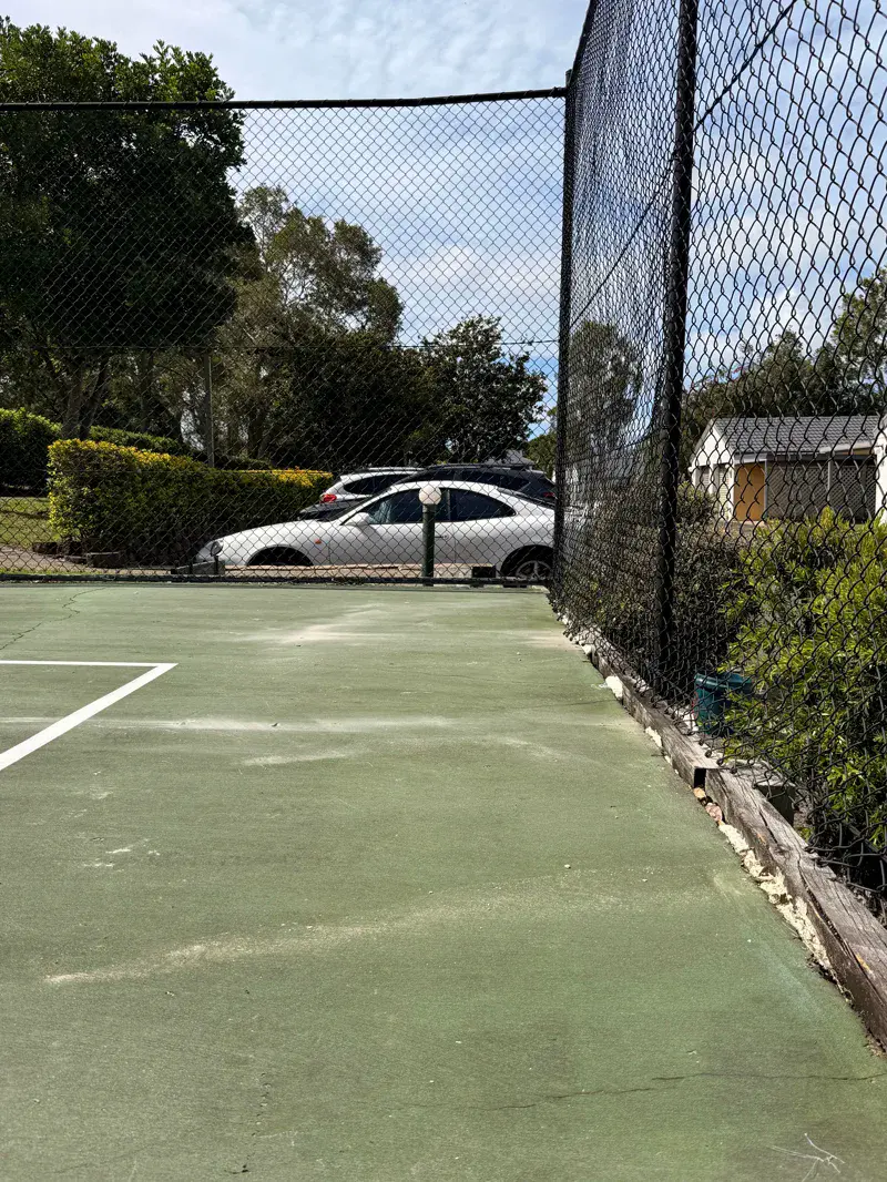 Sunken tennis court showing 100mm drop across playing surface