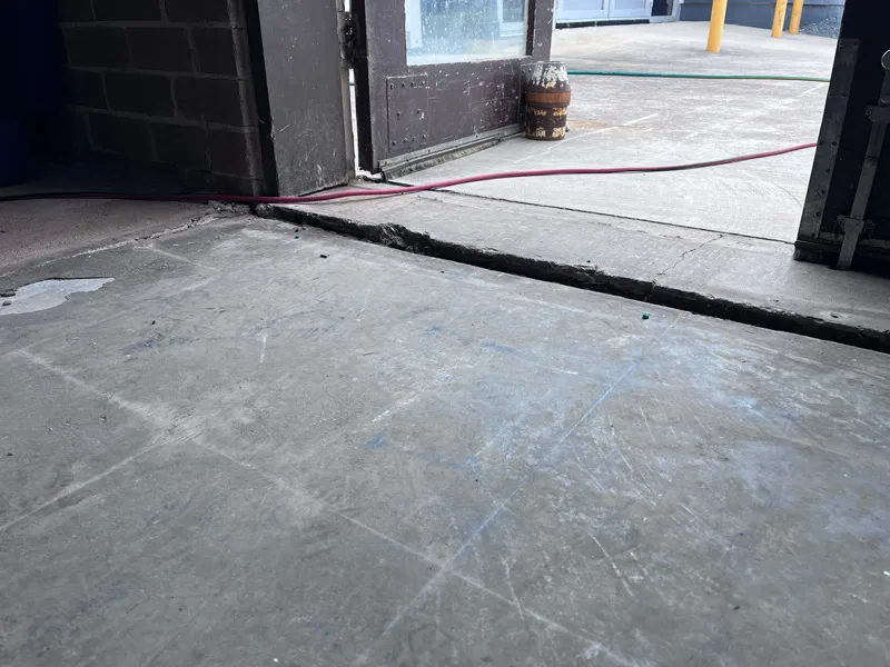 Sunken concrete floor at doorway showing large gap