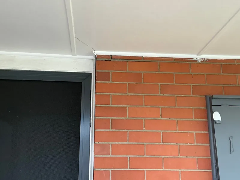 Gap between soffit and brickwork above door frame