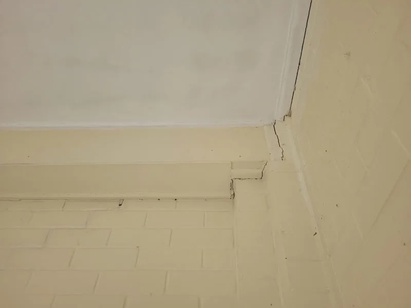 Same ceiling-wall junction showing crack stabilised — after