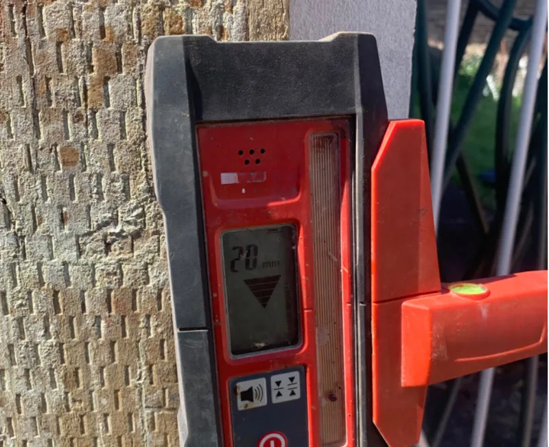 Close-up of laser level receiver showing 20mm reading