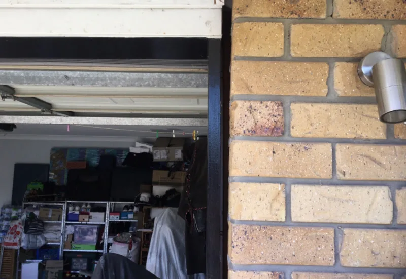 Garage door opening with gap between lintel and brick — before