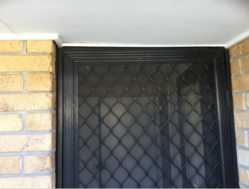 Security screen door top corner with gap in frame — before
