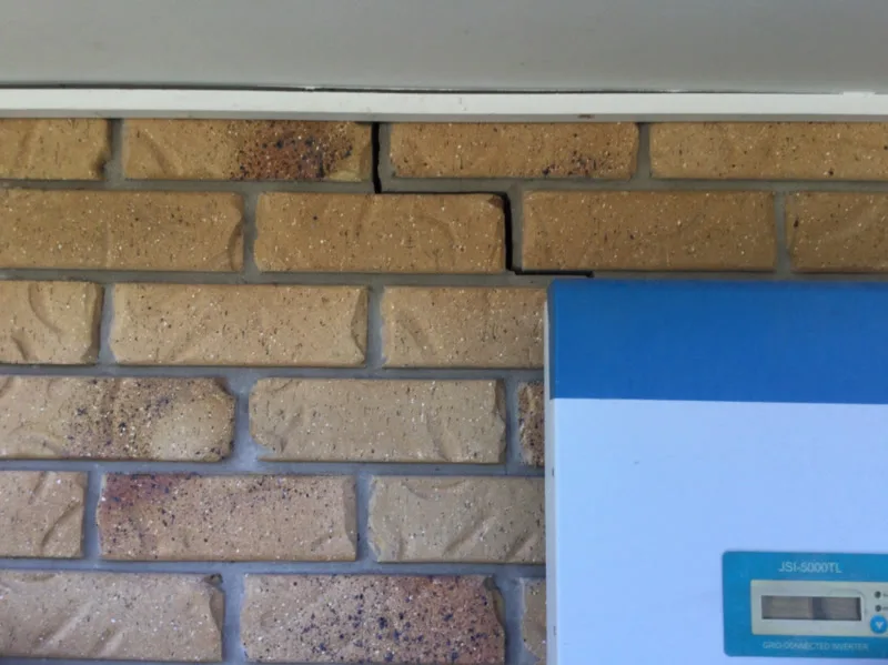 Brick wall area showing crack near inverter — before