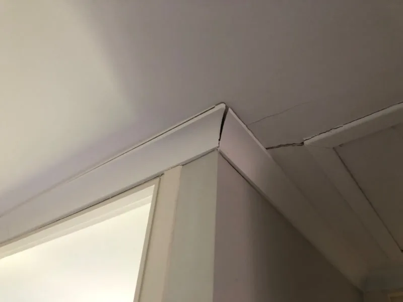 Interior ceiling crack at door frame and cornice junction