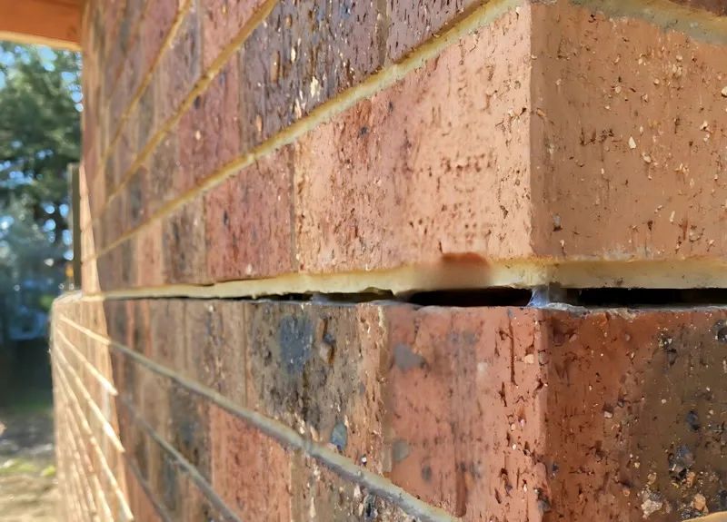 Close-up of horizontal crack in brick mortar joint at corner