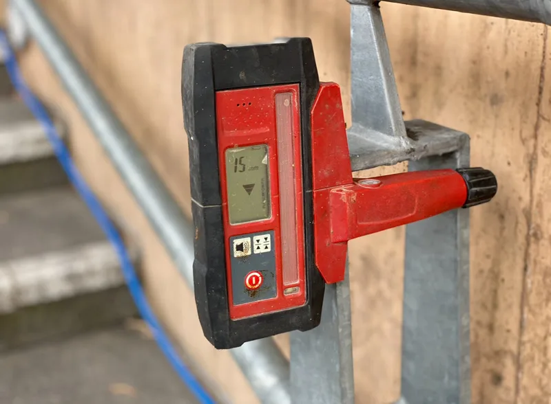 Close-up of laser receiver on stair railing showing 15mm