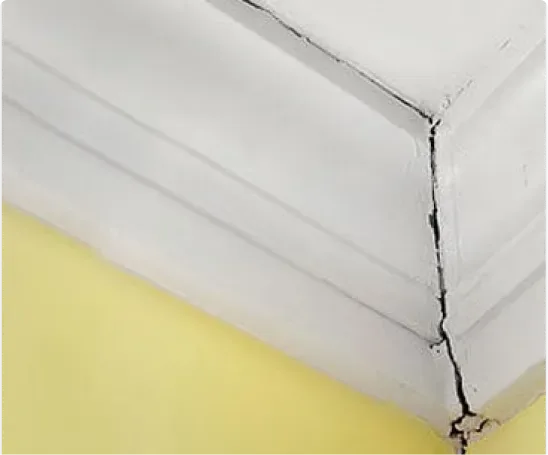 Ceiling-to-wall crack with visible subsidence damage and cornice separation