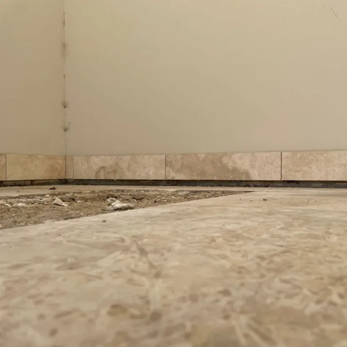 Cracked floor tiles caused by concrete slab movement and ground settlement