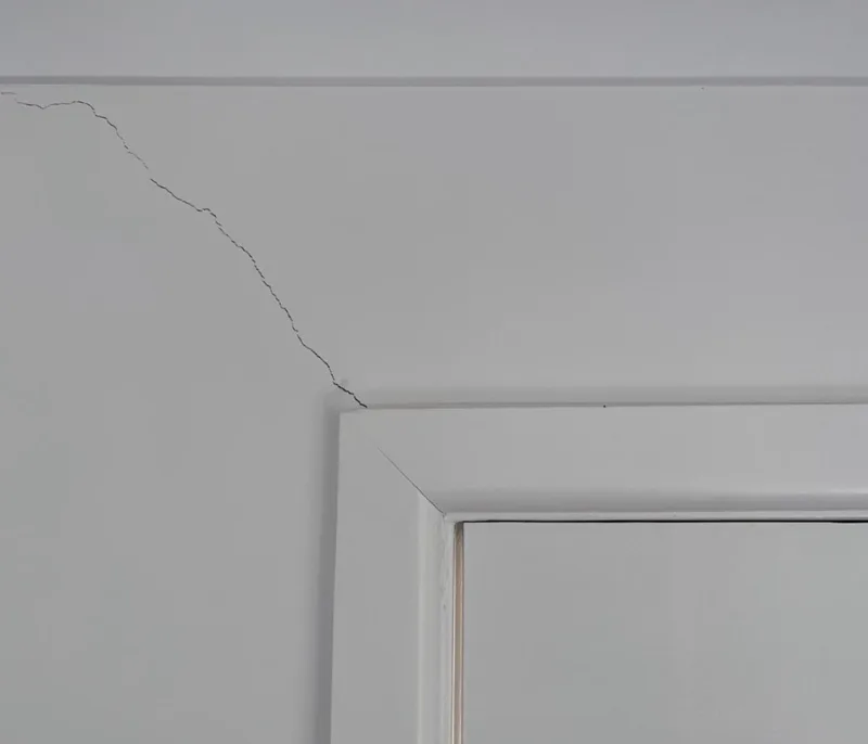 Interior door jamming against concrete floor that has shifted due to slab settlement