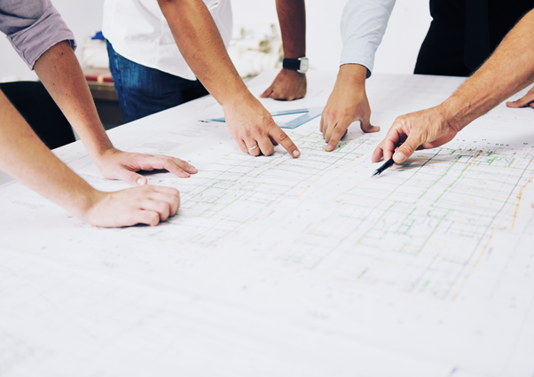 A team of engineers reviewing plans for concrete underpinning