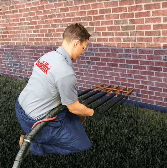 Technician injects GeoPoly treatment to repair foundation subsidence and rising damp.