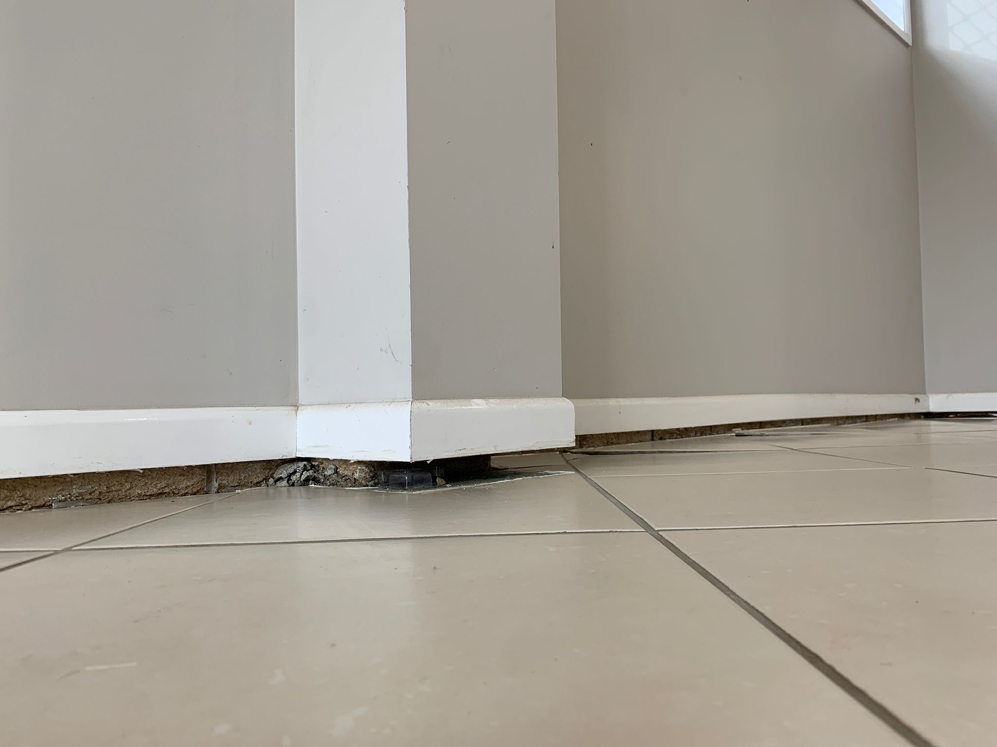 Elevated baseboard and gap indicate subsidence, potential foundation repair needed.
