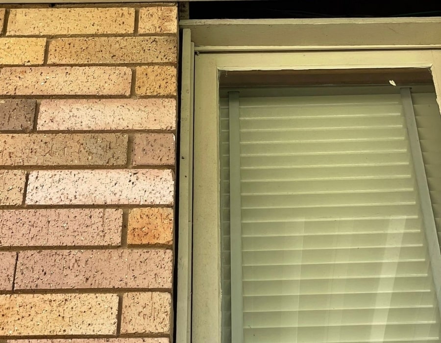 Close-up of brick wall with minor wall cracks needing foundation repair.