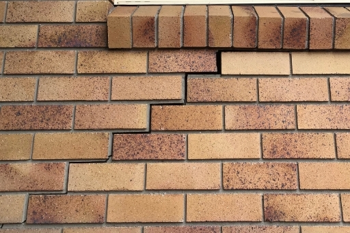 A large crack in the brick wall due to subsidence