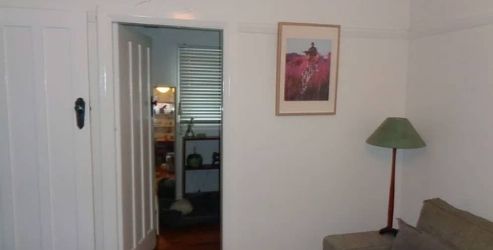 White apartment wall with minor cracks indicating early foundation movement.