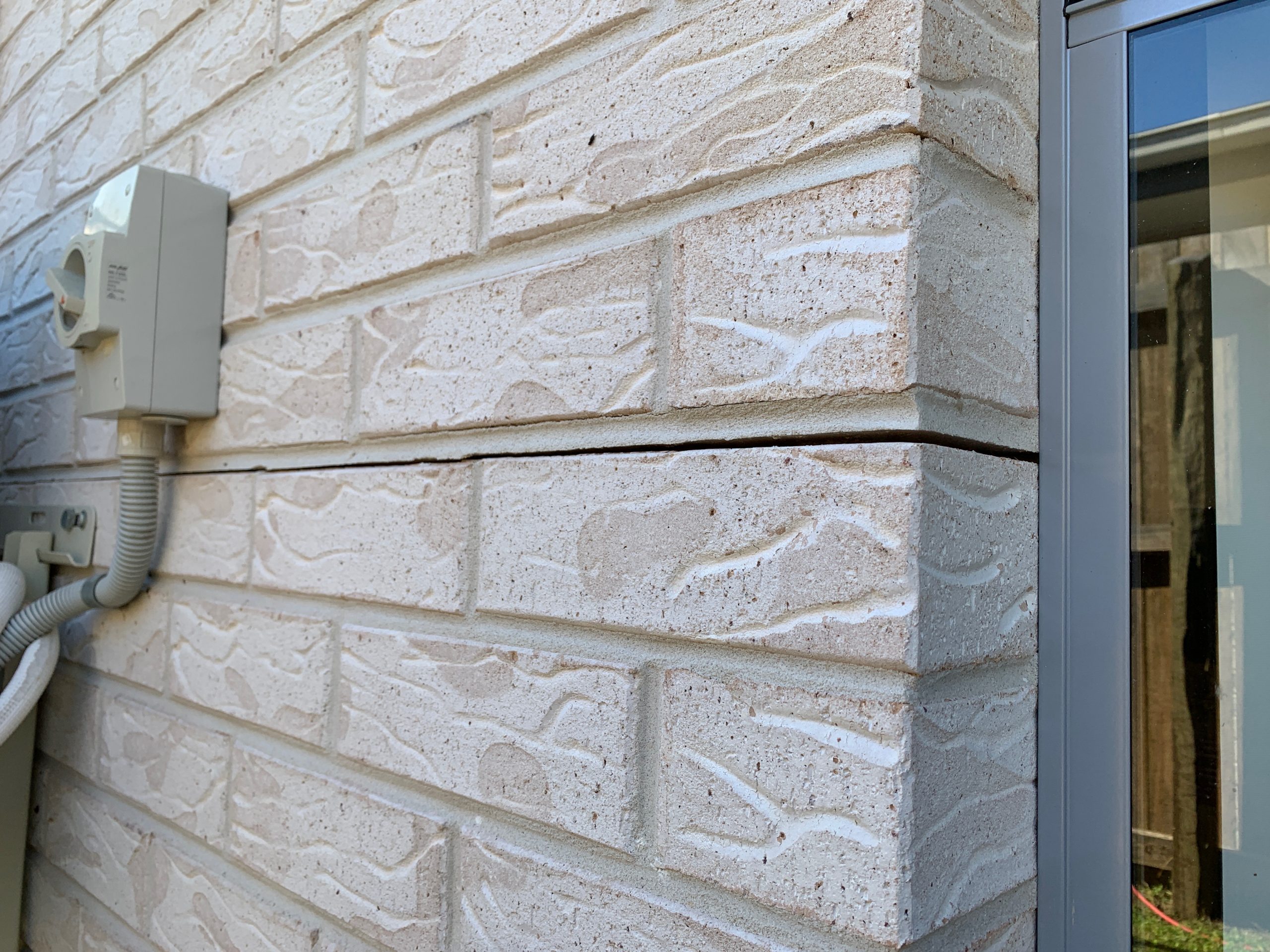 Horizontal wall crack in brickwork indicating subsidence and foundation repair needs.